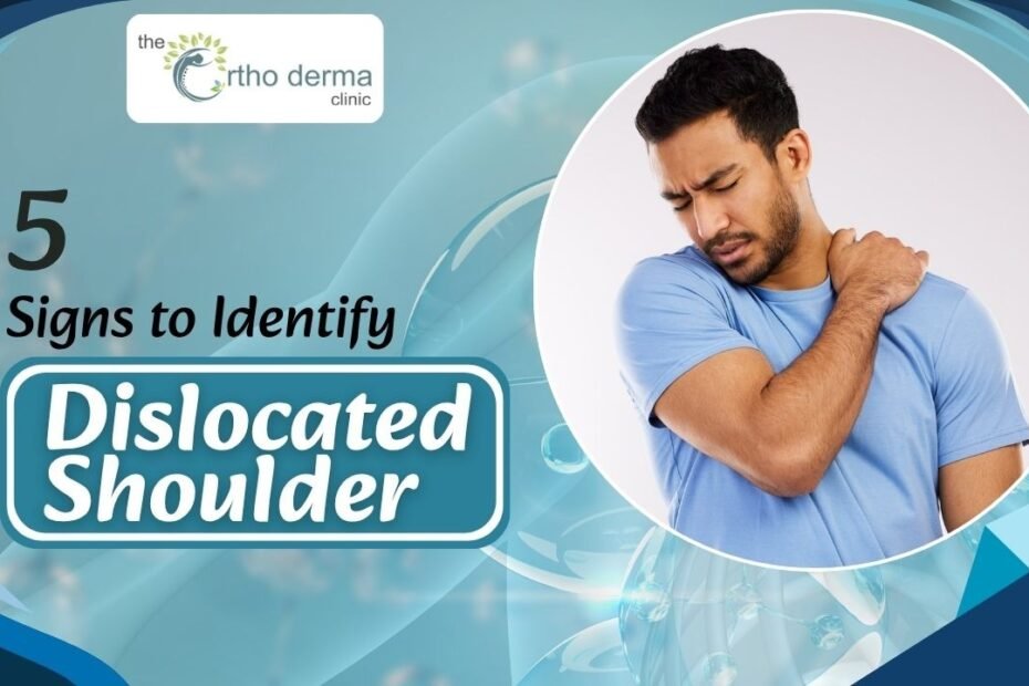 a man in a light blue shirt holding his shoulder in pain